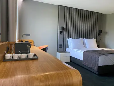 a bedroom with a bed and a table with cups on it at HABAKUK Wellness & Event Hotel in Maribor