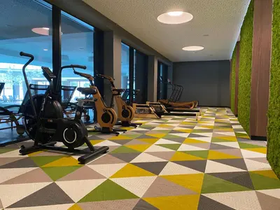 a gym with exercise bikes and ellipticals in a building at HABAKUK Wellness & Event Hotel in Maribor