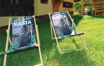 two signs sitting in the grass in a yard at 2 Bedroom Stunning Home In Luce in Luče