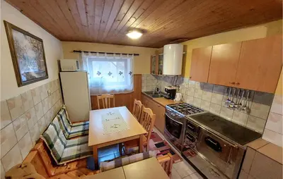 a kitchen with a stove and a table in it at 2 Bedroom Stunning Home In Luce in Luče