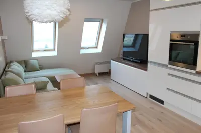 a living room with a table and a tv at ApBovec in Bovec
