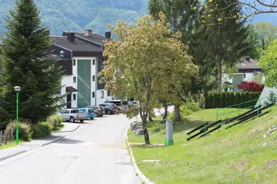 a street with houses and cars parked on a hill at ApBovec in Bovec