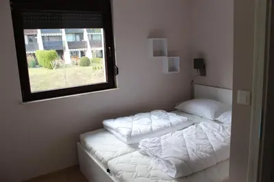 a bedroom with two white pillows on a bed with a window at ApBovec in Bovec