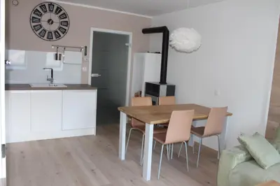 a kitchen and dining room with a wooden table and chairs at ApBovec in Bovec