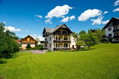a house on a hill with a green lawn at Vila Lipa in Bled