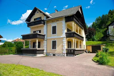 a yellow house with a black roof at Vila Lipa in Bled