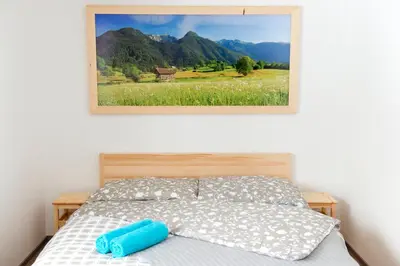 a bedroom with a bed with a picture on the wall at Vila Lipa in Bled