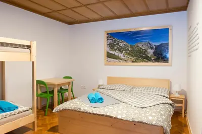 a bedroom with a bed and a desk and a table at Vila Lipa in Bled