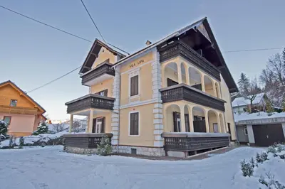 a large house with snow on the ground at Vila Lipa in Bled