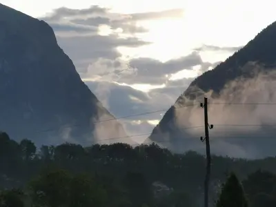 a view of a mountain with clouds in the sky at Apartma Miko in Bovec