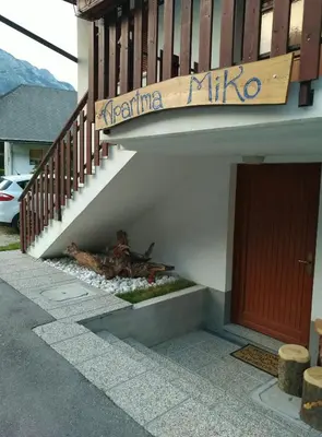 a dead animal laying under a staircase in front of a building at Apartma Miko in Bovec