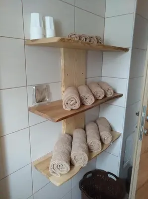 a bunch of towels on shelves in a bathroom at Apartma Miko in Bovec