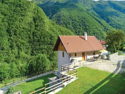 a small house in the middle of a mountain at Počitniška hiša Pri Kuštrču in Grahovo