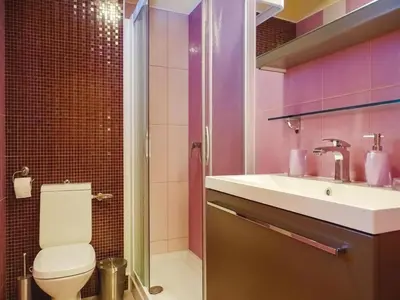 a bathroom with a toilet and a sink at Počitniška hiša Pri Kuštrču in Grahovo