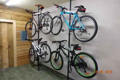 three bikes are hanging on a wall at Počitniška hiša Pri Kuštrču in Grahovo