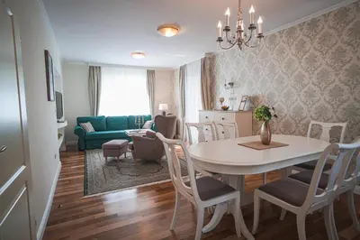 a dining room and living room with a table and chairs at Vacation House Vila Mia in Bled
