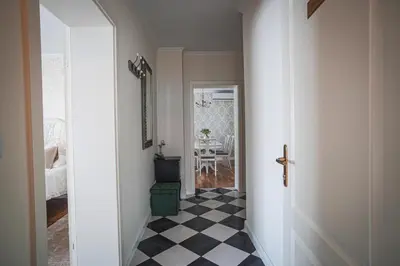 a hallway with a black and white checkered floor at Vacation House Vila Mia in Bled