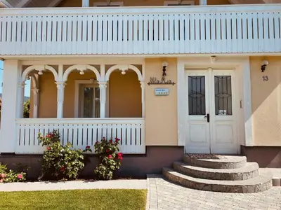 a house with a white door and some stairs at Vacation House Vila Mia in Bled