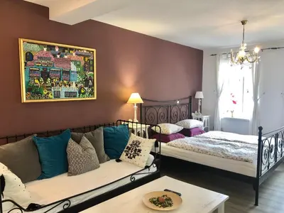 a bedroom with two beds and a couch and a table at Vila Sol in Bled