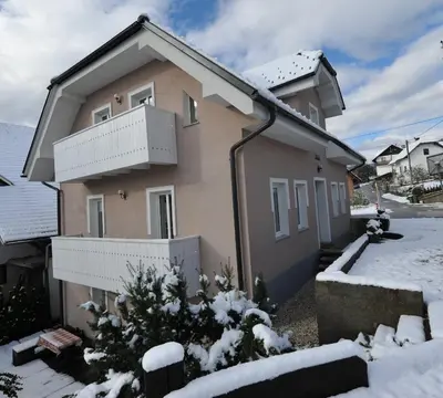 a house with snow in front of it at Vila Sol in Bled