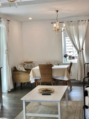 a dining room with a white table and chairs at Vila Sol in Bled