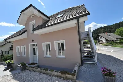 a small house with a staircase in front of it at Vila Sol in Bled