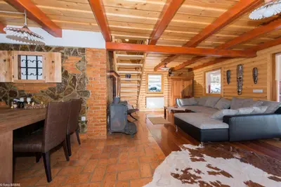 a living room with a couch and a stove at Koča na Planini in Planina pod Sumnikom