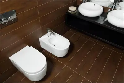 a bathroom with a toilet and two sinks at House Neza in Kranjska Gora