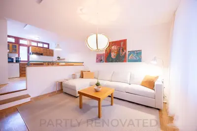 a living room with a white couch and a table at Apartments Baki Kranjska Gora in Kranjska Gora