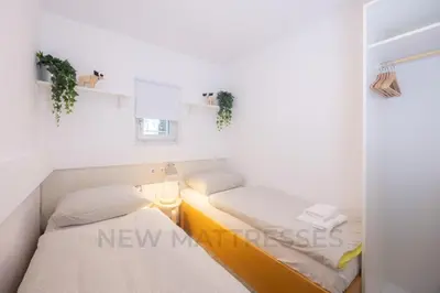a small room with two beds in it at Apartments Baki Kranjska Gora in Kranjska Gora