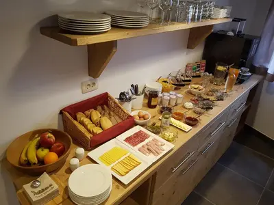 a kitchen with a buffet with food on a table at Hotel Vandot in Kranjska Gora