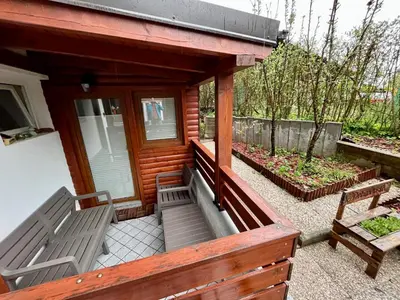 a porch of a house with two benches on it at Apartment TiSa, Bled in Bled