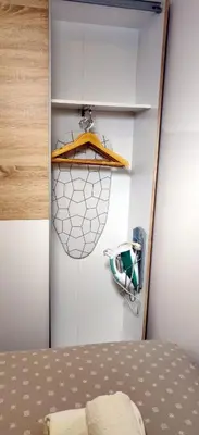a room with a bed and a surfboard on the wall at Apartment TiSa, Bled in Bled