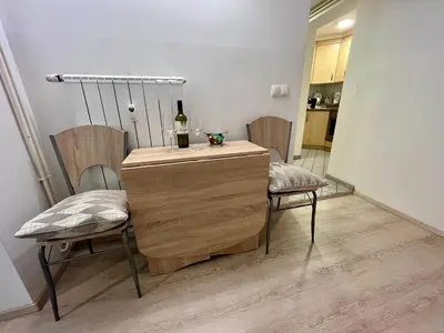 a room with two chairs and a table with a bottle of wine at Apartment TiSa, Bled in Bled