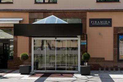 a entrance to a building with a black awning at Hotel Piramida in Maribor