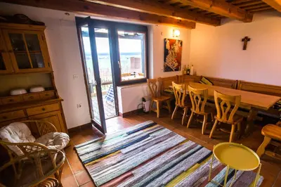 a living room with a table and chairs and a rug at Vineyard Living in Filovci