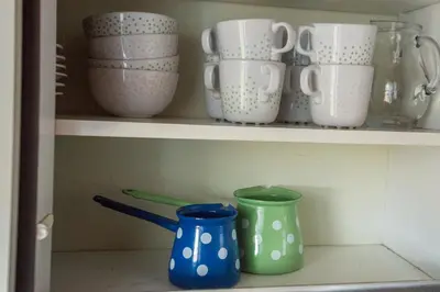 a shelf with bowls and cups on it at Vineyard Living in Filovci