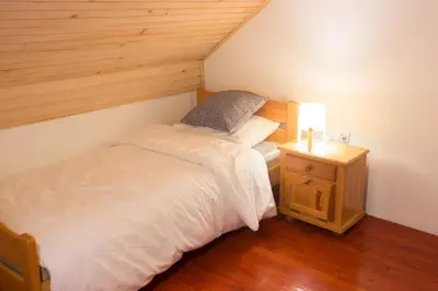a small bedroom with a bed and a night stand at Vineyard Living in Filovci