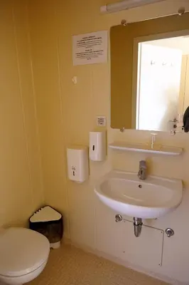 a bathroom with a sink and a toilet and a mirror at Saint Ignatius Retreat House in Ljubljana