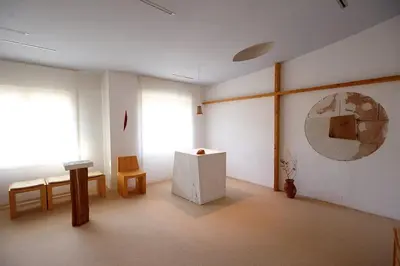 a room with two windows and a table and chairs at Saint Ignatius Retreat House in Ljubljana