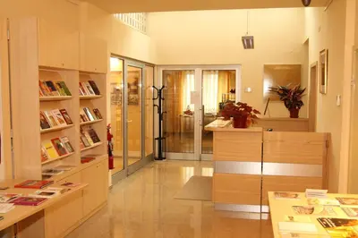 a room with a library with a desk and bookshelves at Saint Ignatius Retreat House in Ljubljana