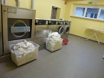 a laundry room with two washers and a dryer at Hotel Emonec in Ljubljana