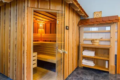 a bathroom with a sauna with wooden walls at Török rooms, bistro & wellness in Lesce