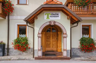 a front door of a building with a clock pattern at Török rooms, bistro & wellness in Lesce