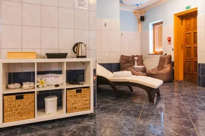 a living room with a table and a couch at Török rooms, bistro & wellness in Lesce