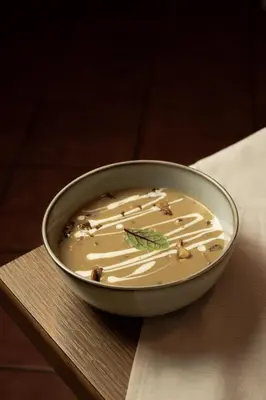 a bowl of soup sitting on a table at Török rooms, bistro & wellness in Lesce