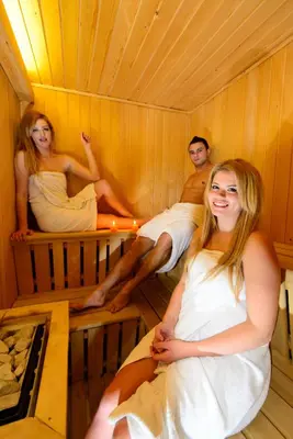 a group of people sitting in a sauna at Boutique Hotel Loka in Škofja Loka