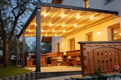 a pergola with lights on a patio at Boutique Hotel Loka in Škofja Loka