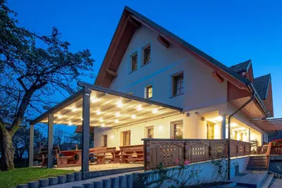 a large white house with a pergola at Boutique Hotel Loka in Škofja Loka