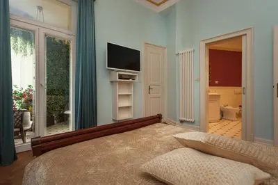 a bedroom with a bed and a television in a room at Filip’s Palace Luxurious Apartment in Ljubljana